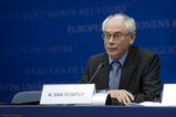 Van Rompuy zit voor een microfoon