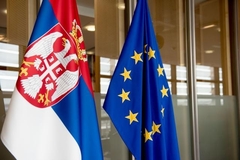 Serbian flag, on the left, and the European Union flag