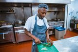 Een chef snijdt groenten in de keuken